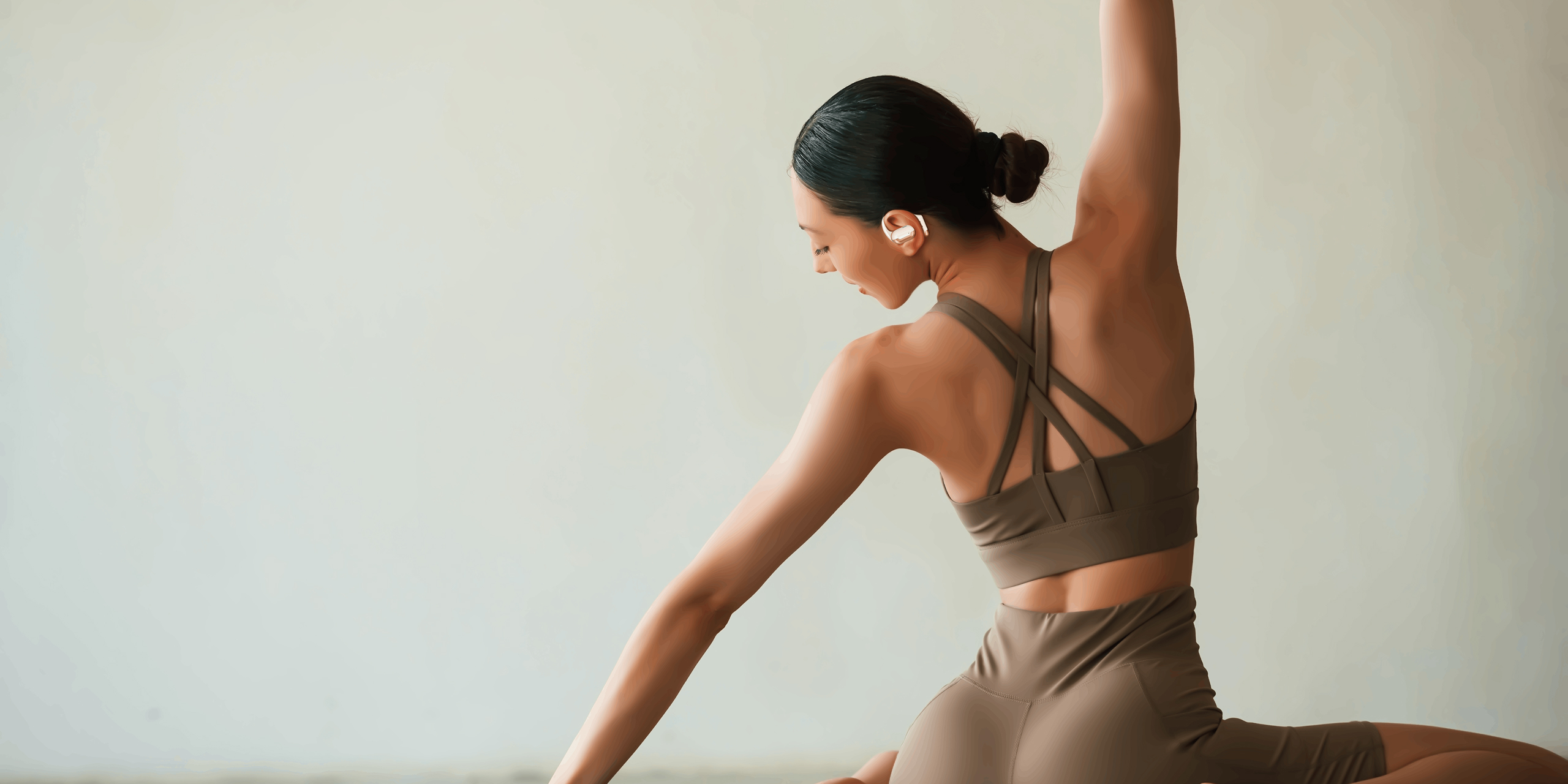 A fitness enthusiastic women exercising while listening a song in FINGERS OWaveS open ear pods