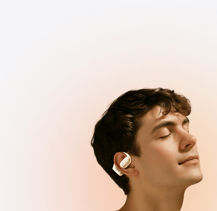 A young man wearing a FINGERS OWaveS on ear earphones and fully immersed